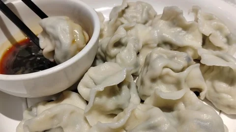 Chopsticks Picking Up Dumpling and Dipping into Vinegar, Food Close-up Stock Footage 332411054
