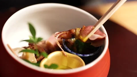 Chopsticks Picking Up Firefly Squid from a Gourmet Japanese Kaiseki Appetizer Stock Footage 334832165