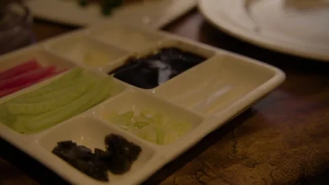 Chopsticks Selecting Condiments from Divided Plate in Beijing Restaurant Setting Stock Footage 345762539