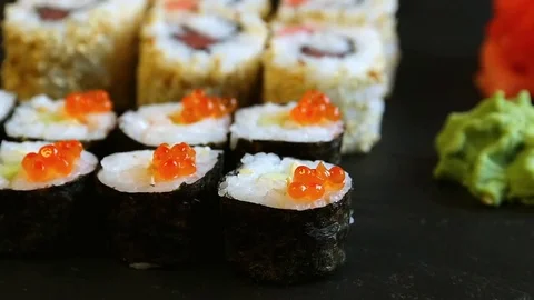 Chopsticks taking portion of sushi roll with red caviar Stock Footage 70390298