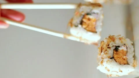 Chopsticks taking portion of sushi roll. Sushi rolls with salmon cream cheese Stock Footage 292117130