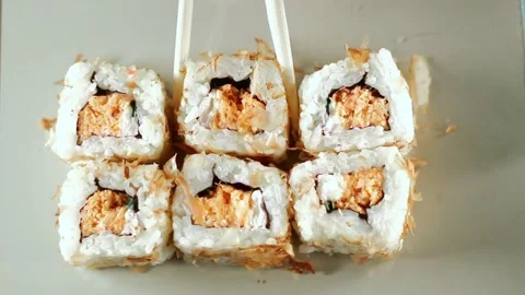 Chopsticks taking portion of sushi roll. Sushi rolls with salmon cream cheese Stock Footage 292117140