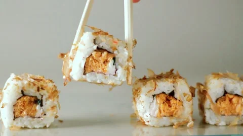 Chopsticks taking portion of sushi roll. Sushi rolls with salmon cream cheese Stock Footage 293195566