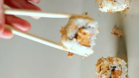 Chopsticks taking portion of sushi roll. Sushi rolls with salmon cream cheese Stock Footage 293195590