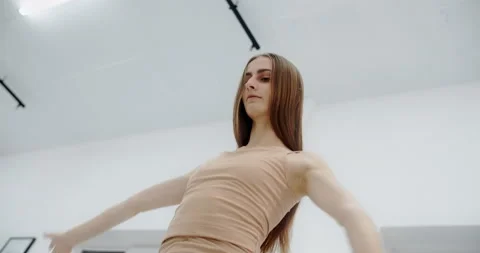 Choreographer dances in the white ballet class, graceful art dance in slow Stock Footage 148540365