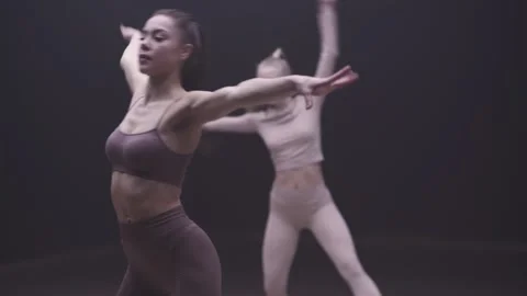 Choreography, two young women performs a stretching dance with yoga elements in Stock Footage 263950618