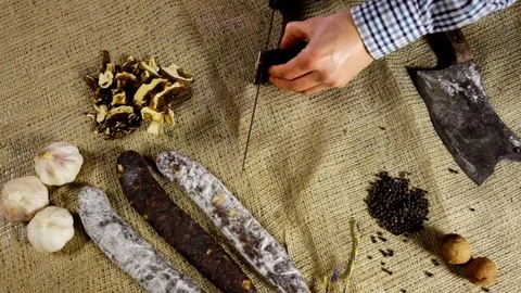 Chorizo sausage is being cut to tiny slices Stock Footage 102586195