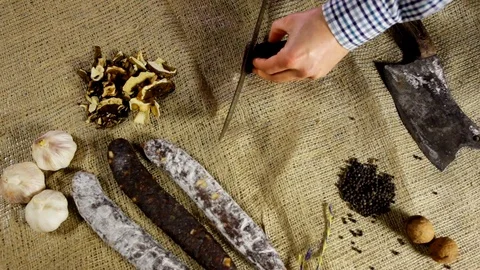 Chorizo sausage is being cut to tiny slices Stock Footage 102586222