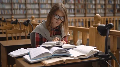 Chosing a Book in Library Видео 81516658