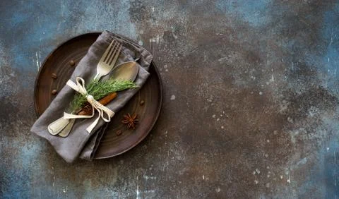 Chrismas table place setting. Tableware with evergreen twigs, cone and spice Stock Photos