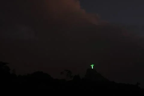 Christ the Redeemer 'dresses' in green to ask for help, Rio De Janeiro, Brazil - Stock Photos