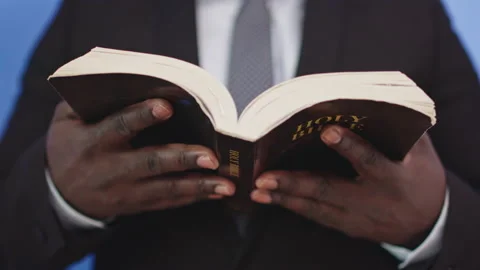 Christian black church father reading holy bible closeup Stock Footage