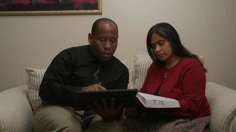 Christian Couple Having Bible Study Using Bible and Electronic Tablet Stock Footage 110905631