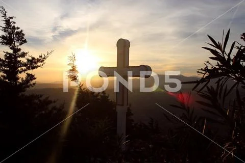 Christian cross in sunset lighting Stock Photos