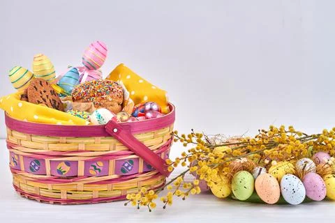 Christian easter tradition concept. Willow and mimosa with coloured eggs. Stock Photos