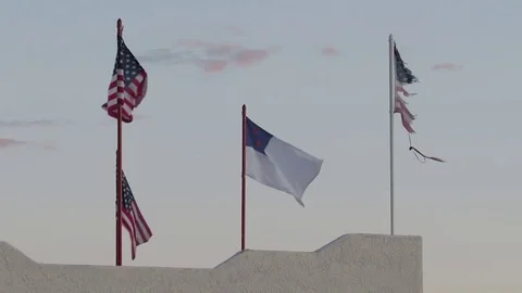 A Christian Flag and badly tattered US Flag seen in northern Arizona Stock Footage 80461553