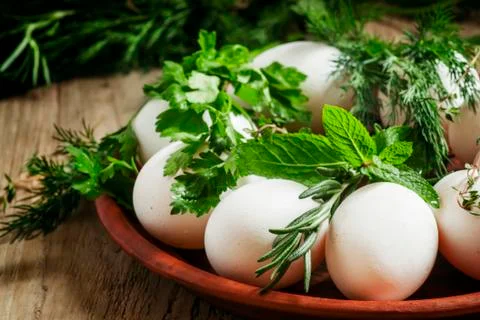 Christian tradition dyeing Easter eggs with a pattern of herbs, eggs and herb Stock Photos