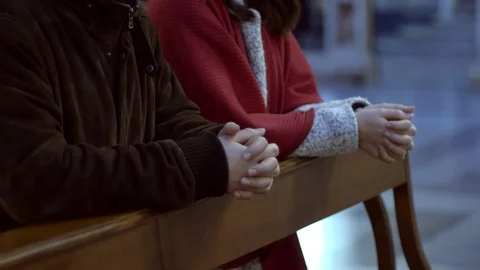 Christianity, faith, prayer - couple hands praying in church Stock Footage
