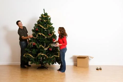 Christmas: adding ornaments to tree Stock Photos