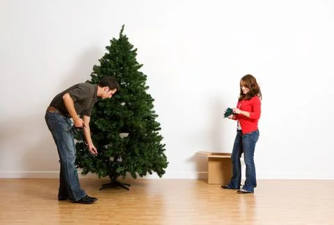 Christmas: adding strands of lights Stock Photos