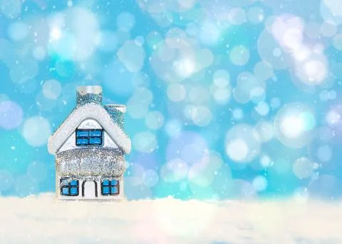 Christmas and New Year card.Toy house in the snow on a blue background. Stock Photos