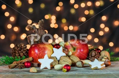 Christmas arrangement with sparklings lights background, food and reindeer Stock Photos