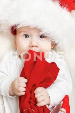 Christmas baby portrait, Kid holding red xmas bag Stock Photos