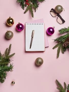 Christmas background with blank notebook surrounded by Christmas decorations Stock Photos
