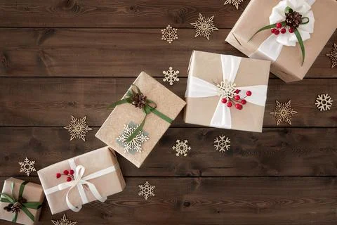 Christmas background with border of gift boxes on dark brown wood background Stock Photos