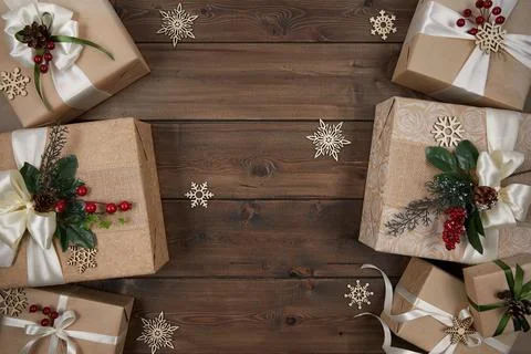 Christmas background with borders of gift boxes on dark brown wood background Stock Photos