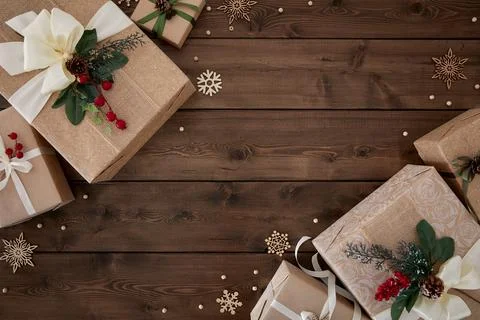 Christmas background with borders of gift boxes on dark brown wood background Stock Photos