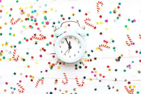 Christmas background with candy canes with alarm clock and multicolored sequi Fotos Stock