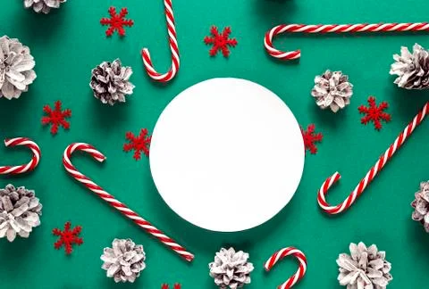 Christmas background with candy canes, pine cones and space for text. Stock Photos