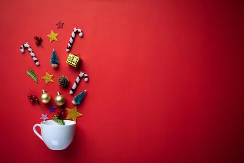 Christmas background concept. Top view of white cup splash out Christmas deco Stock Photos