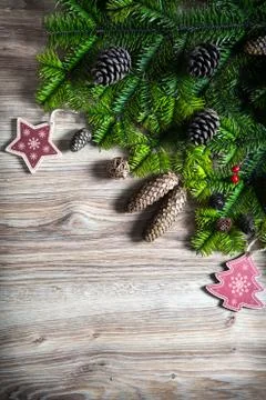 Christmas background with decorations and pine cones, on wooden board Stock Illustration