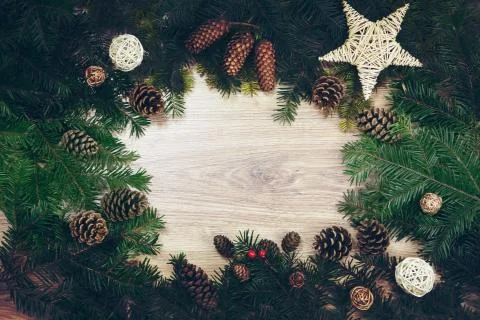 Christmas background with decorations and pine cones, on wooden board Stock Illustration