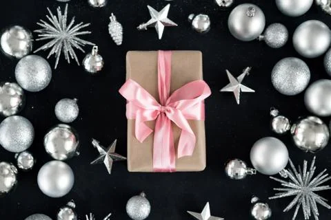 Christmas background with decorations, gift box with pink ribbon, top view on Stock Photos