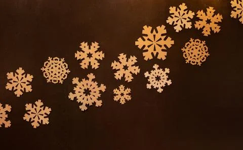 Christmas background with different types of snowflakes on a black wall Stock Photos