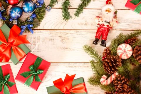 Christmas background frame with gift present boxes, fir pine and Santa Claus Stock Photos