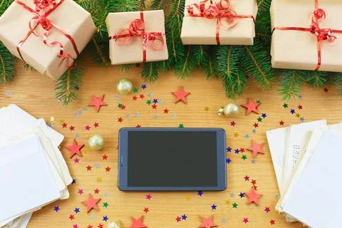 Christmas background with gift bags, Tablet with black screen and letters on Stock Photos