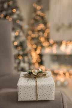 Christmas background with a gift box on a light background with a garland out of Stock Photos
