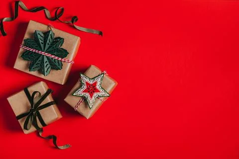 Christmas background with gift boxes, clews of rope and decorations on red. P Stock Photos