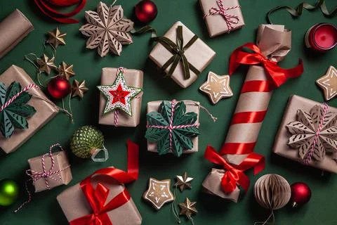 Christmas background with gift boxes, clews of rope and decorations on green. Stock Photos