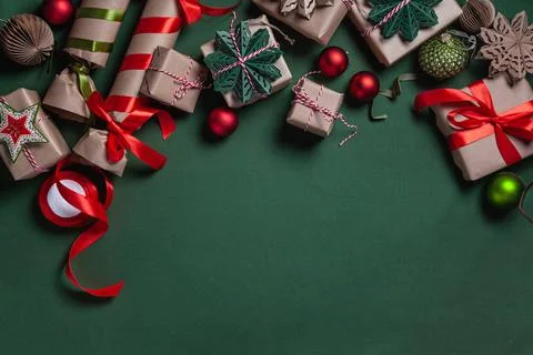 Christmas background with gift boxes, clews of rope and decorations on green. Stock Photos
