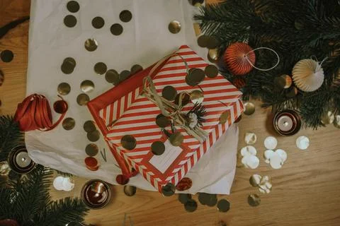 Christmas background with gift boxes, clews of rope, paper's rools, pine tree an Stock Photos