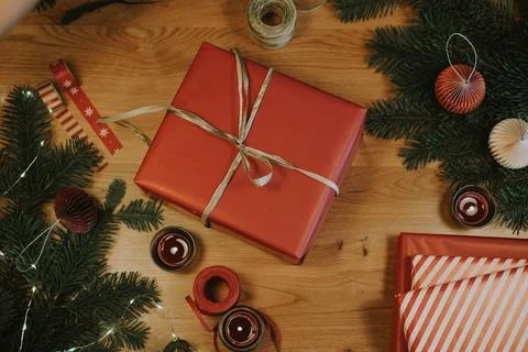 Christmas background with gift boxes, clews of rope, paper's rools, pine tree an Stock Photos