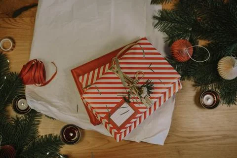 Christmas background with gift boxes, clews of rope, paper's rools, pine tree an Stock Photos