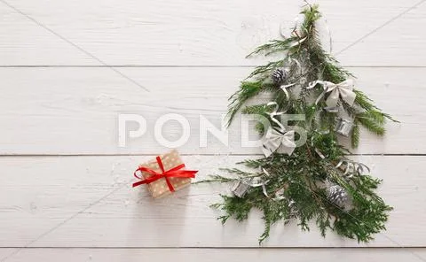 Christmas background. Gift boxes on fir tree at white wood Stock Photos