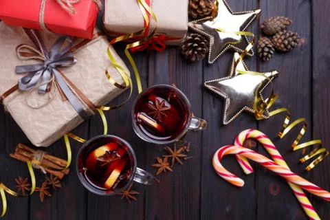 Christmas background with gift boxes, mulled wine and decoration Stock Photos