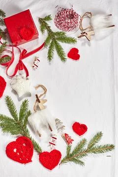Christmas background with gift boxes, ribbon, twine, paper rolls, knitted h.. Stock Photos